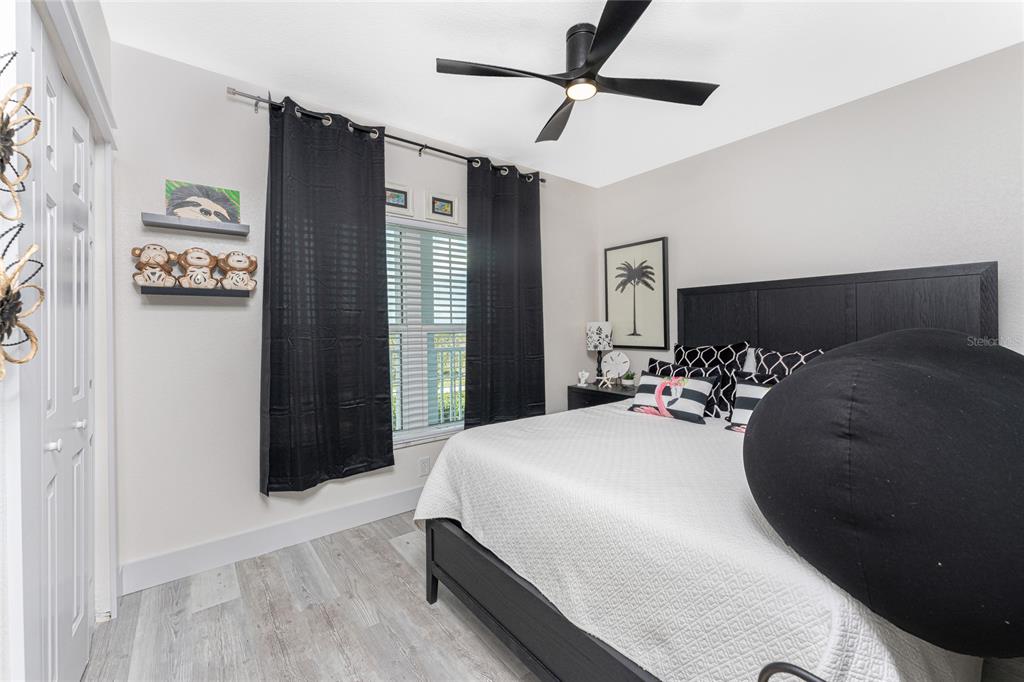 8405 Placida Road, Unit 406 Placida, FL 33946 - Photo 31 of 55 a bedroom with a large bed and a closet