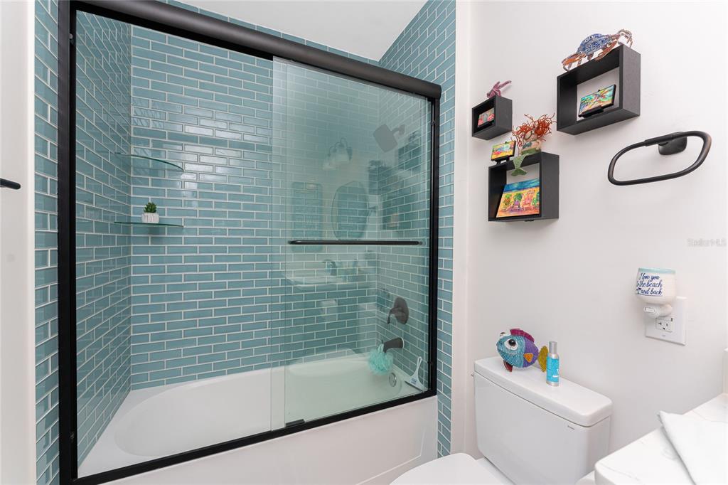 8405 Placida Road, Unit 406 Placida, FL 33946 - Photo 35 of 55 a bathroom with a shower a toilet and a bathtub