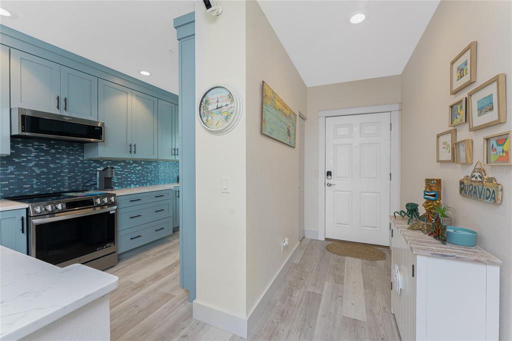 8405 Placida Road, Unit 406 Placida, FL 33946 - Photo 4 of 55 a kitchen with stainless steel appliances granite countertop a refrigerator and a stove top oven