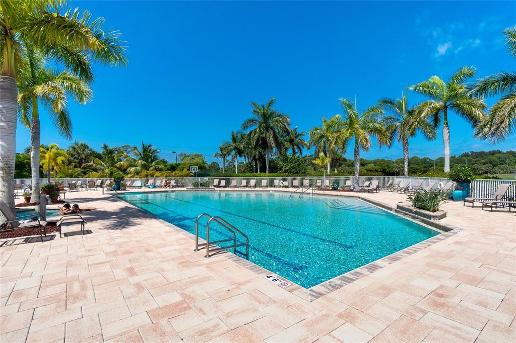 8405 Placida Road, Unit 406 Placida, FL 33946 - Photo 49 of 55 a view of swimming pool with outdoor seating and palm tree