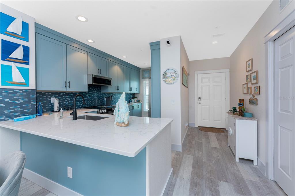 8405 Placida Road, Unit 406 Placida, FL 33946 - Photo 5 of 55 a kitchen with a sink a stove and cabinets