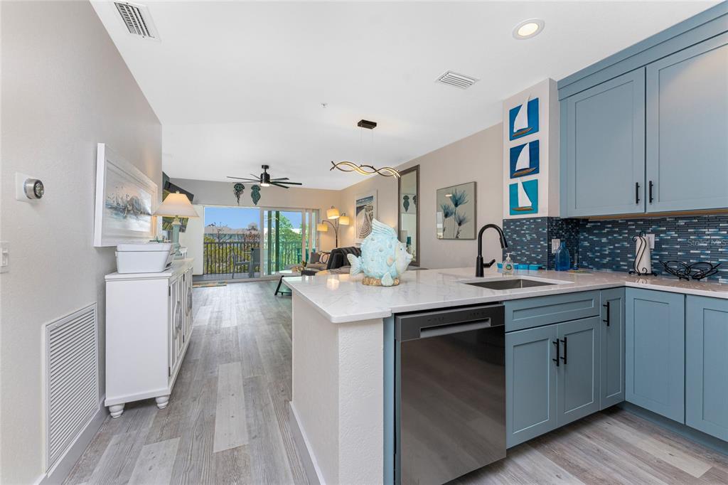 8405 Placida Road, Unit 406 Placida, FL 33946 - Photo 6 of 55 a kitchen with a sink stove and cabinets