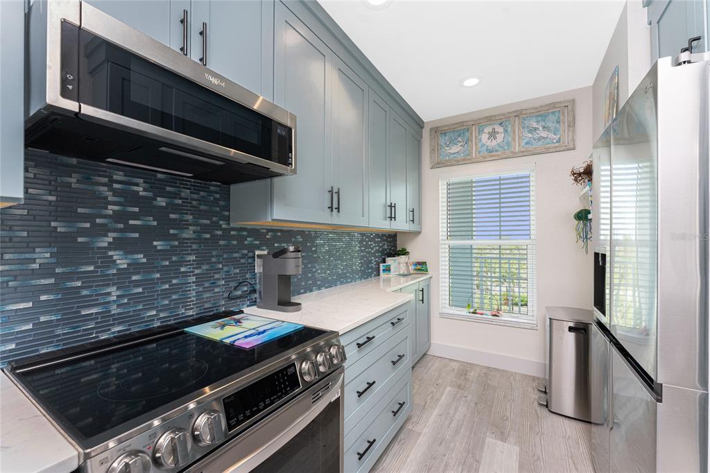 8405 Placida Road, Unit 406 Placida, FL 33946 - Photo 9 of 55 a kitchen with a stove and a microwave