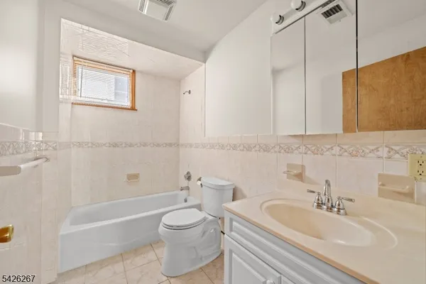 a bathroom with a toilet a sink and bathtub