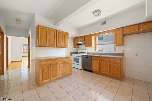 a kitchen with stainless steel appliances granite countertop a sink and cabinets