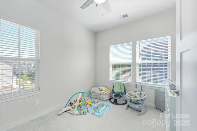 a bathroom with a toilet a sink a mirror and a window