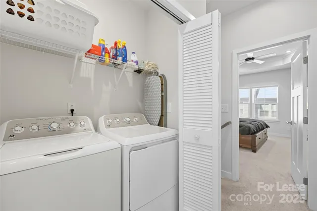 a large bed sitting in a bedroom next to a window