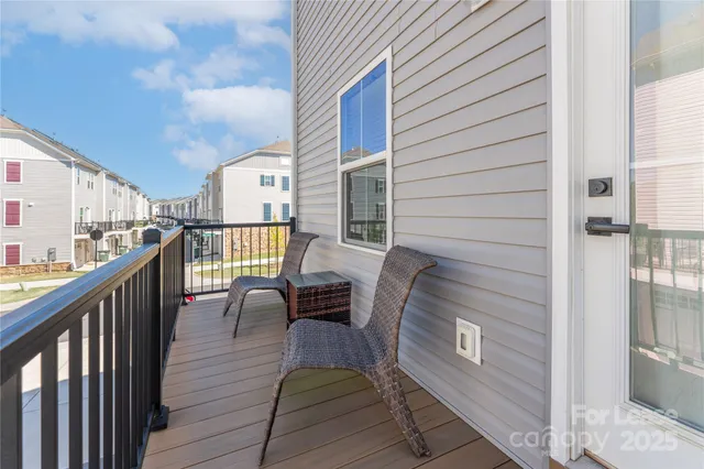 a front view of a building with lot of cars and trees