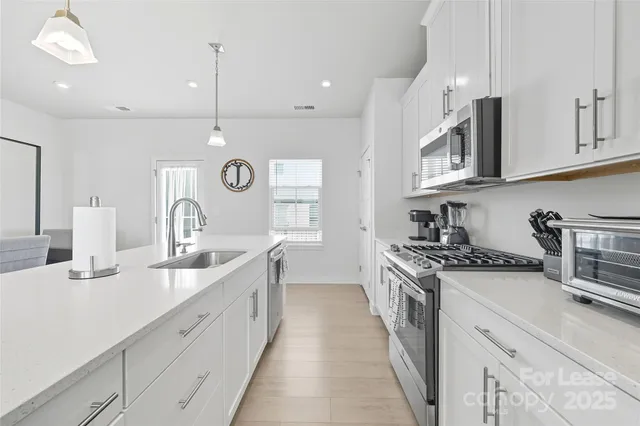 a view of a dining room with furniture and a window
