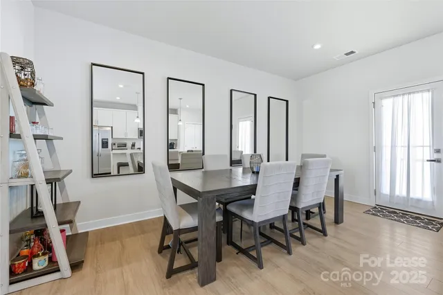 a open kitchen with white cabinets and stainless steel appliances