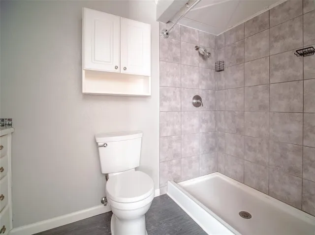 a bathroom with a toilet and bathtub