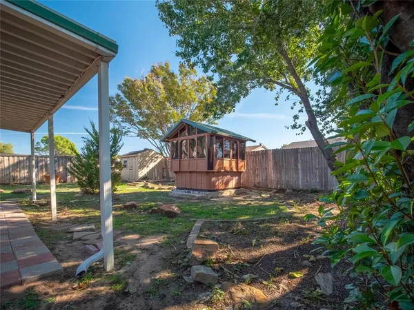a view of yard with swimming pool and sitting area