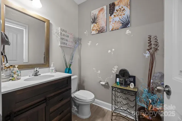 a spacious bathroom with a sink a toilet and a mirror