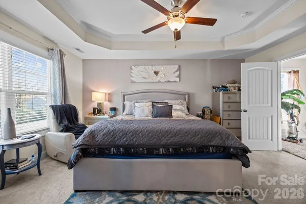 a bedroom with a bed couch and window