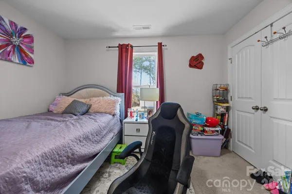 a bed room with a bed and a chair