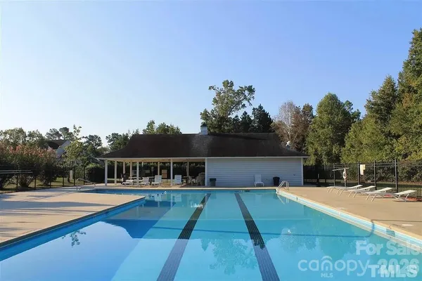 a view of house with swimming pool