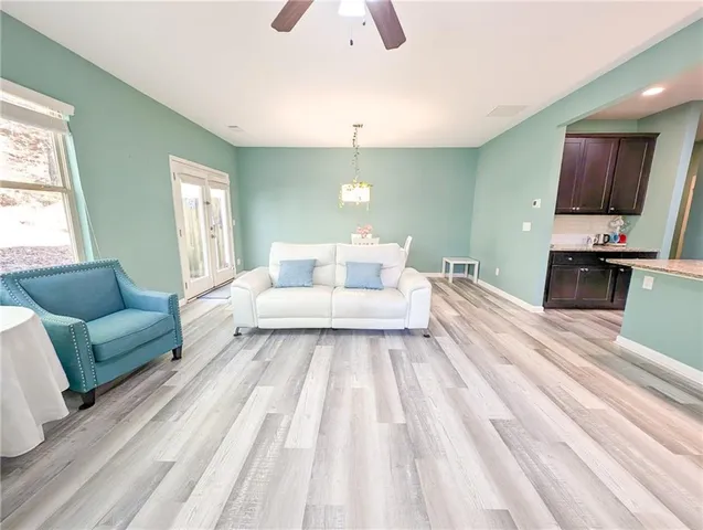 a view of a dining room with furniture a chandelier and wooden floor