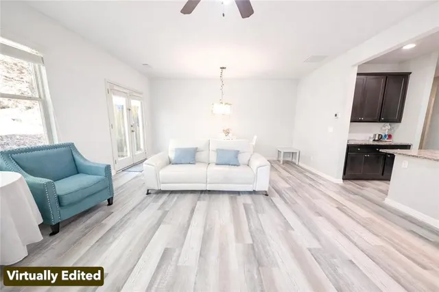 a living room with furniture and a chandelier
