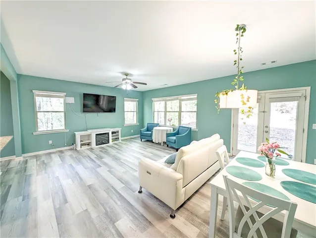 a kitchen with stainless steel appliances kitchen island granite countertop a sink refrigerator and cabinets