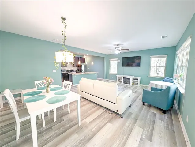 a kitchen with kitchen island granite countertop a sink cabinets and stainless steel appliances