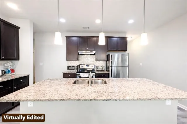 a bathroom with a sink vanity and mirror