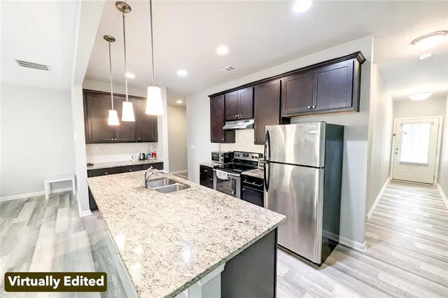 a spacious bedroom with a large bed a flat tv screen and a dresser