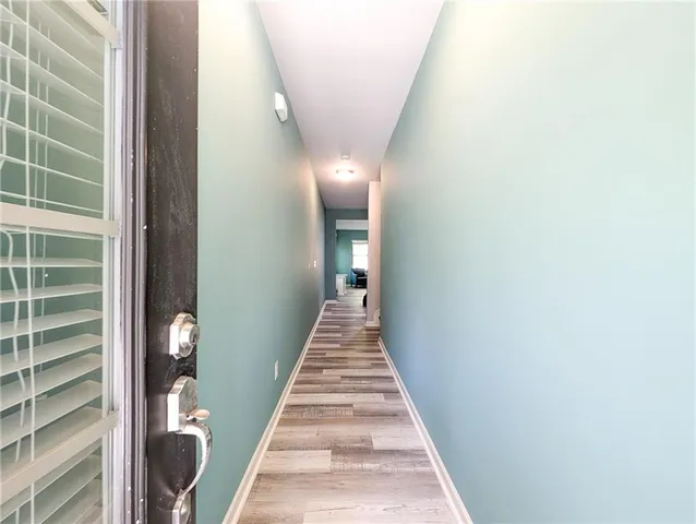 a view of a hallway with wooden floor