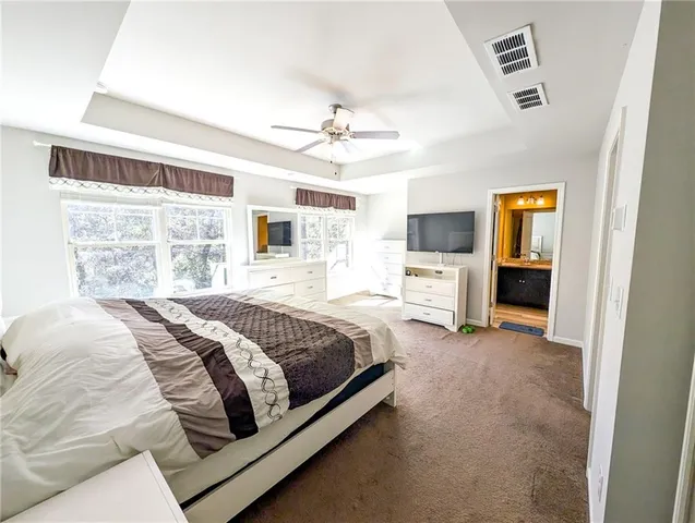 a living room with a bed and a window