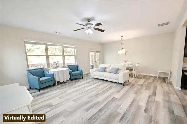 a living room with furniture flat screen tv and window