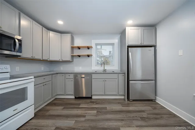 a kitchen with stainless steel appliances granite countertop a refrigerator sink and cabinets