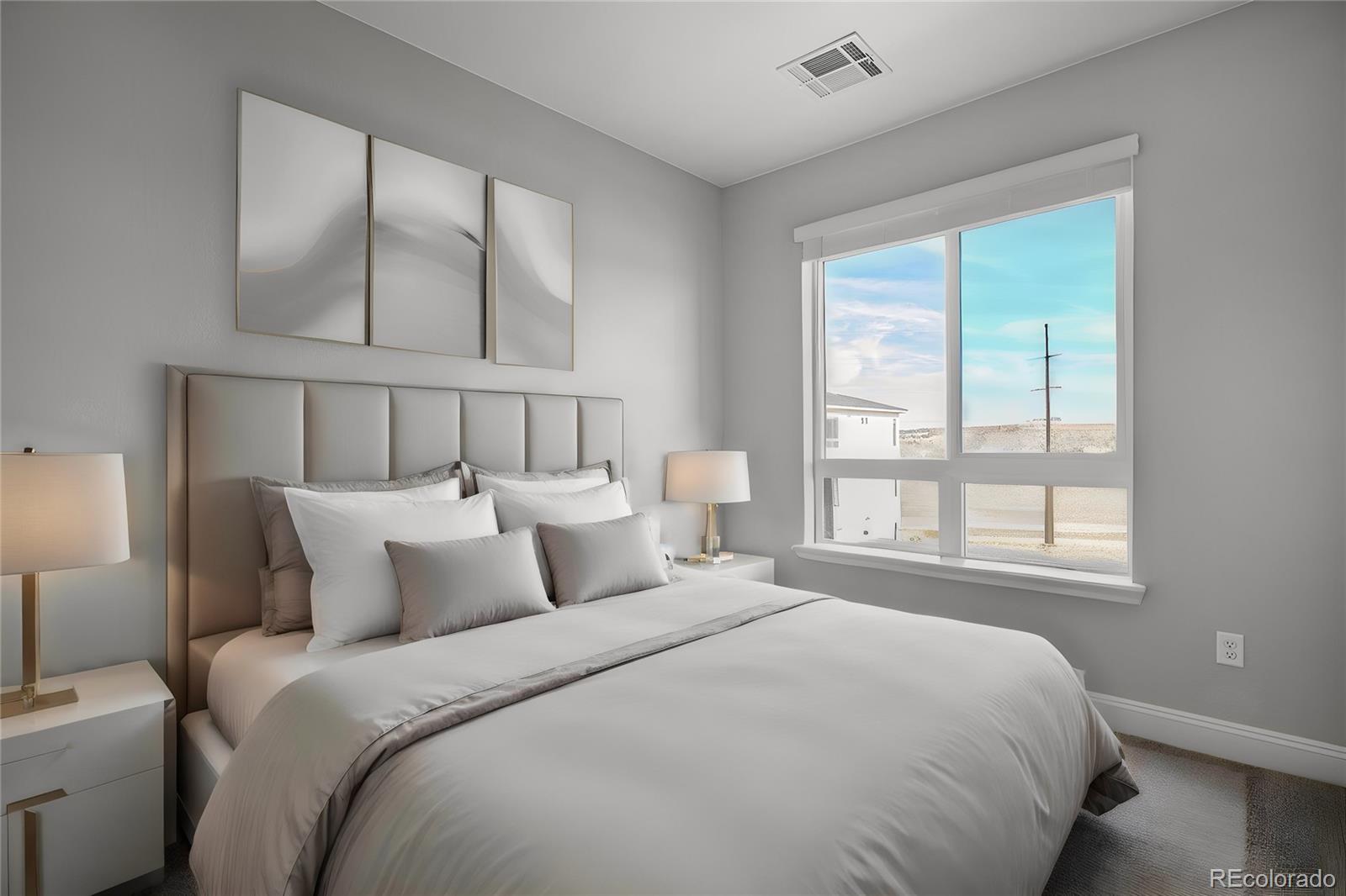 16881 Askins Loop, Unit 302 Parker, CO 80134 - Photo 5 of 11 a bedroom with a large bed and a window