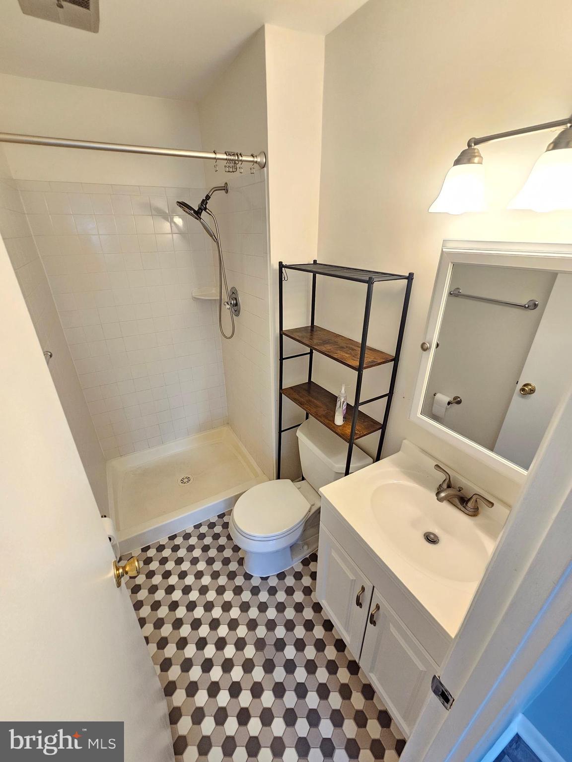 17445 Hoskinson Road Poolesville, MD 20837 - Photo 28 of 37 a bathroom with a sink toilet a shower and a mirror
