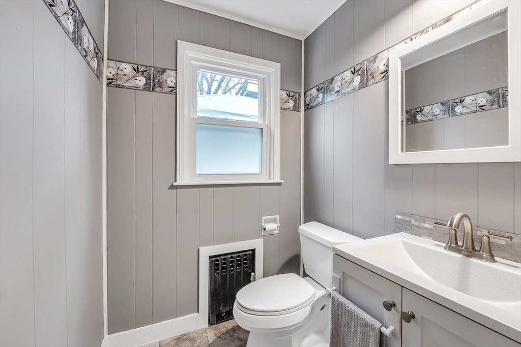 22 Lanark Street Worcester, MA 01603 - Photo 13 of 33 a white toilet sitting next to a bathroom sink