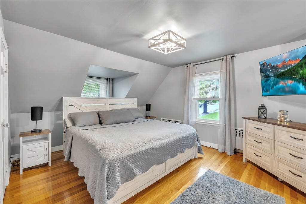 22 Lanark Street Worcester, MA 01603 - Photo 15 of 33 a spacious bedroom with a bed and a flat screen tv