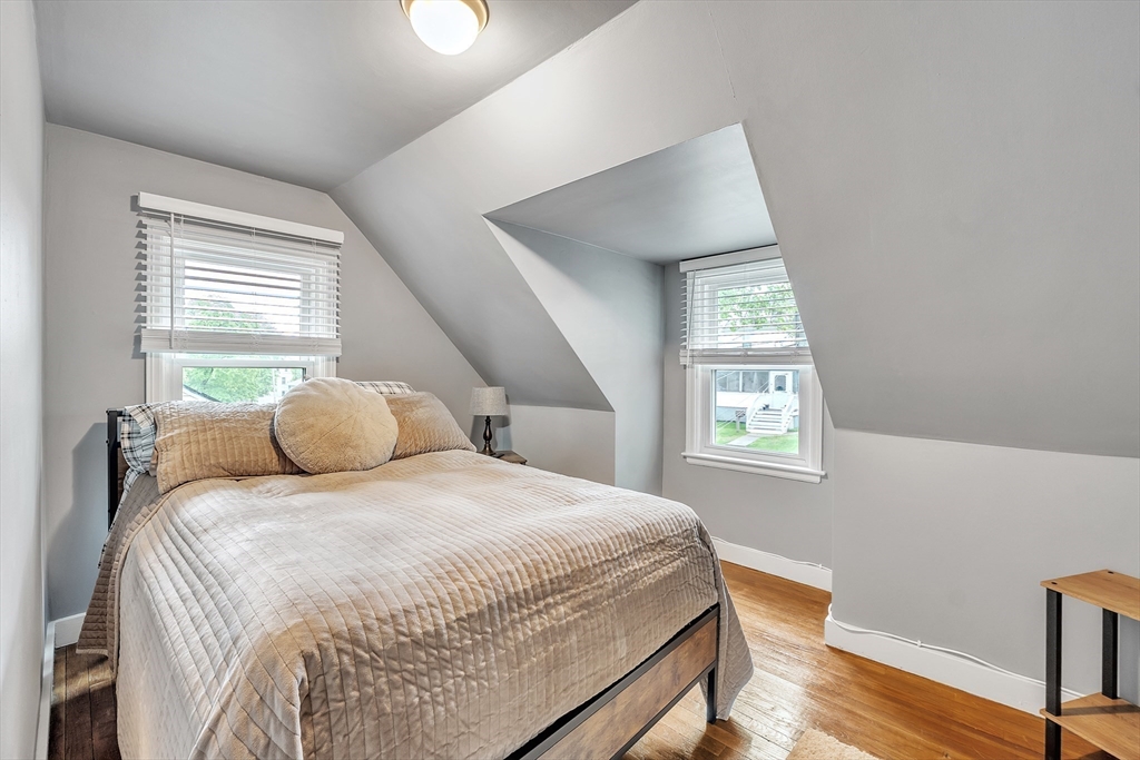 22 Lanark Street Worcester, MA 01603 - Photo 18 of 33 a bedroom with a bed and wooden floor