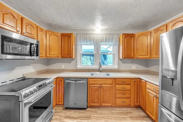 a kitchen with a sink stove and cabinets