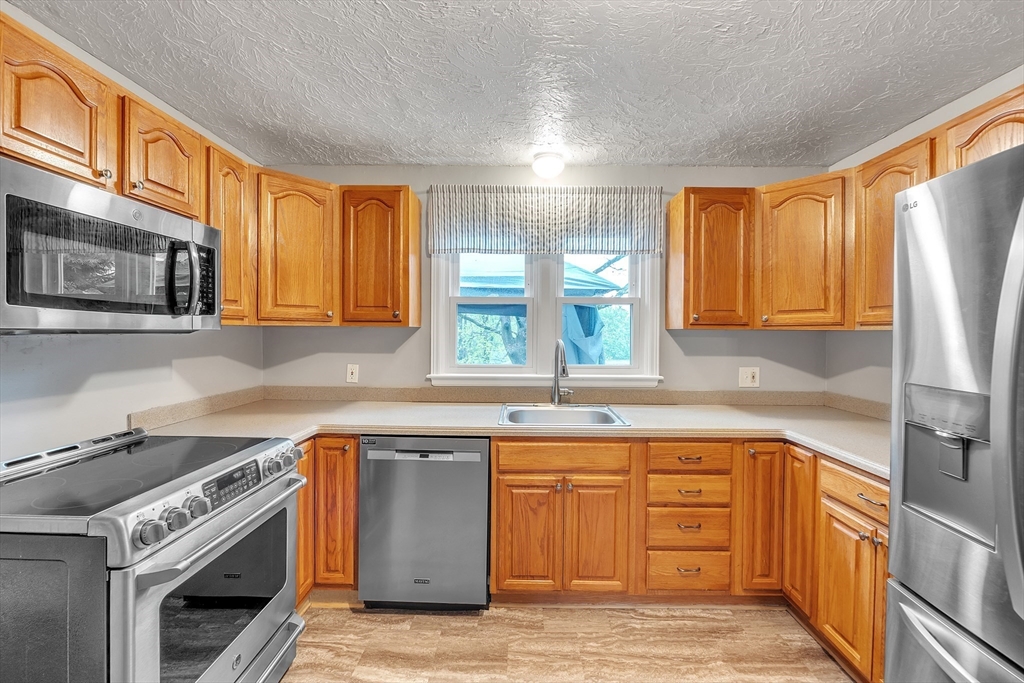 22 Lanark Street Worcester, MA 01603 - Photo 3 of 33 a kitchen with a sink stove and cabinets