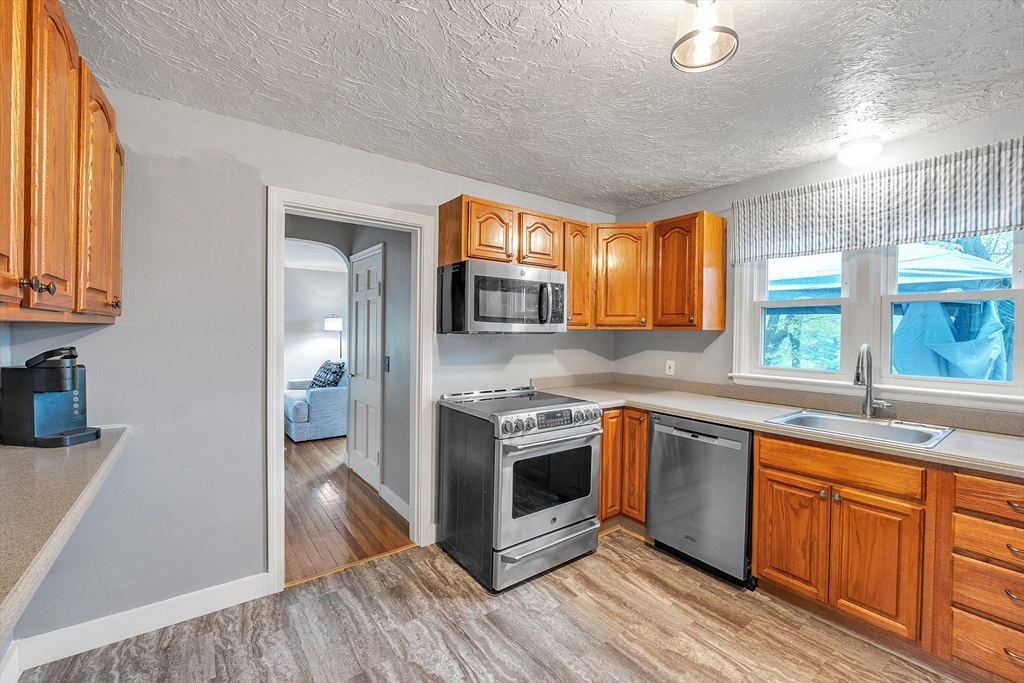22 Lanark Street Worcester, MA 01603 - Photo 5 of 33 a kitchen with stainless steel appliances granite countertop a stove a sink and a refrigerator