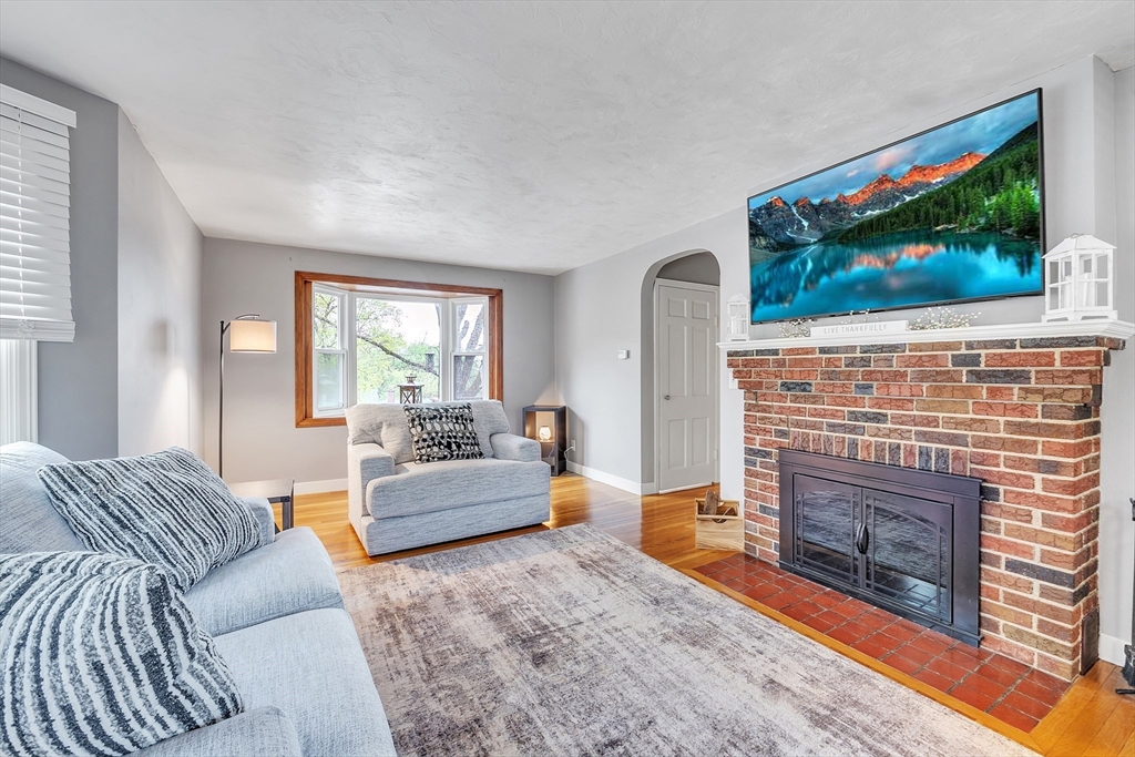 22 Lanark Street Worcester, MA 01603 - Photo 10 of 33 a living room with furniture a flat screen tv and a fireplace