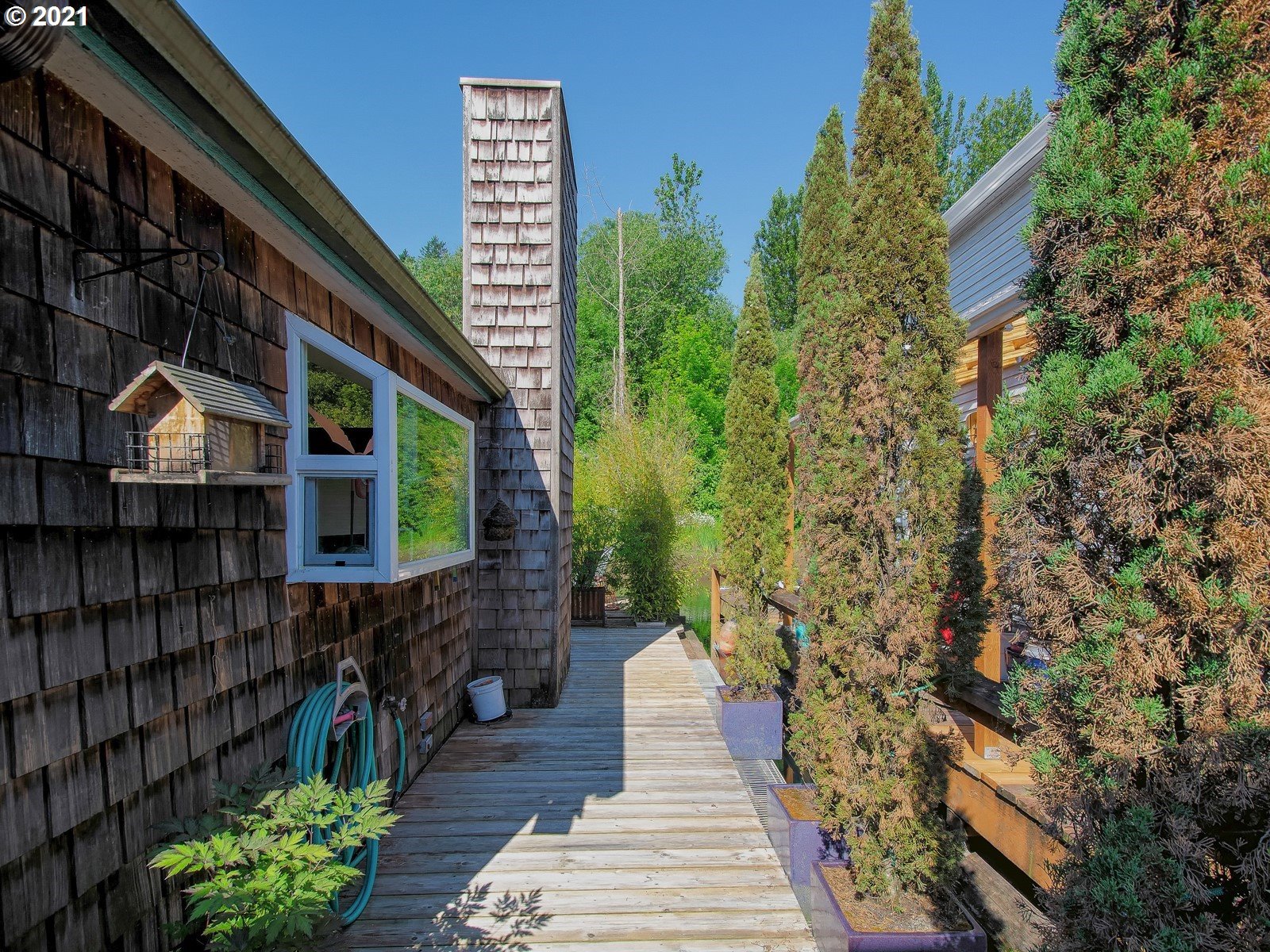 7720 South Macadam Avenue, Unit 8 Portland, OR 97219 - Photo 2 of 32 a pathway of a house with wooden fence