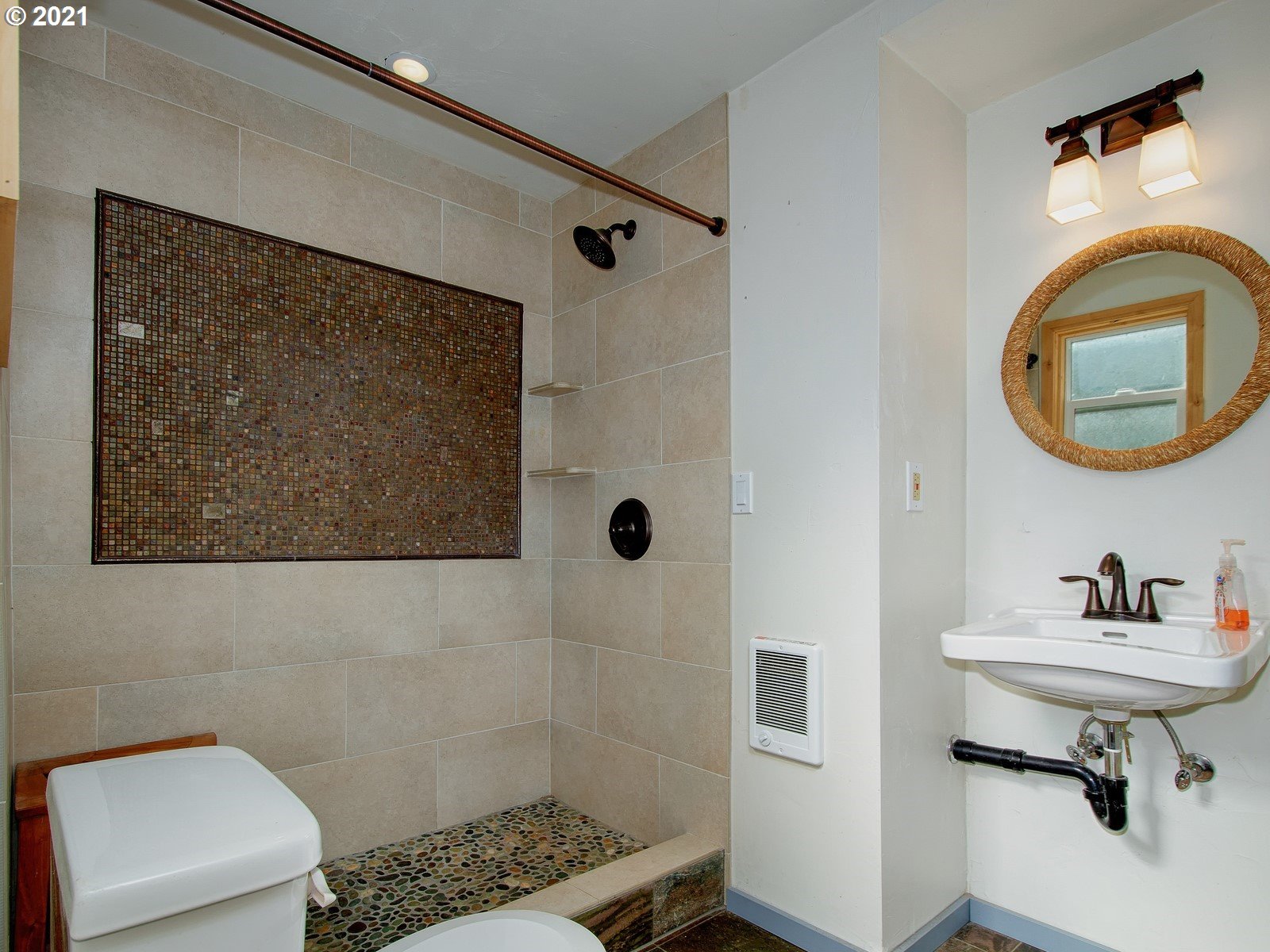 7720 South Macadam Avenue, Unit 8 Portland, OR 97219 - Photo 14 of 32 a bathroom with a sink a mirror and a shower