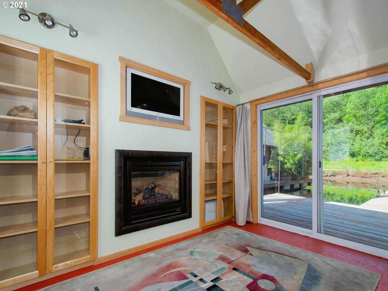7720 South Macadam Avenue, Unit 8 Portland, OR 97219 - Photo 21 of 32 a living room with a fireplace and a floor to ceiling window
