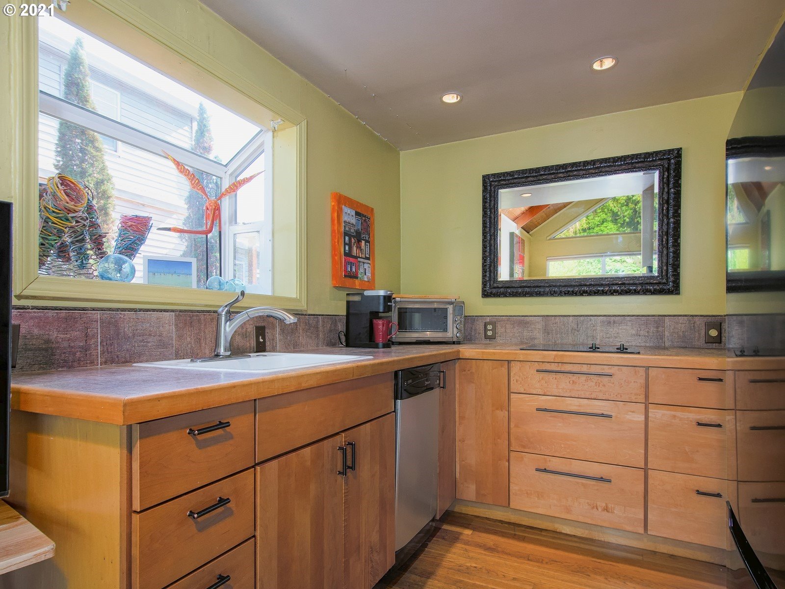 7720 South Macadam Avenue, Unit 8 Portland, OR 97219 - Photo 9 of 32 a view with cabinets a sink and a window