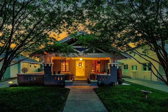 a view of house with yard and deck