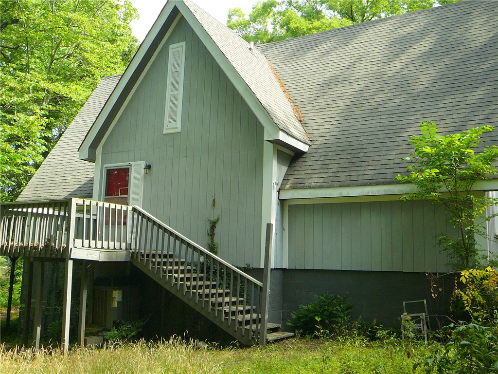 117 C-14-70 Anderson, SC 29621 - Photo 5 of 7 A charming A-frame structure with a welcoming elevated porch awaits, nestled amongst lush greenery.