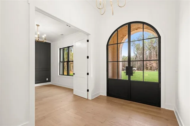 a view of an empty room with a fireplace and a window