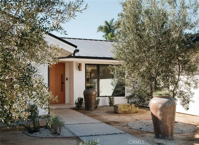 a kitchen with table chairs refrigerator and microwave