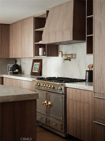 a kitchen with a sink a stove and kitchen island