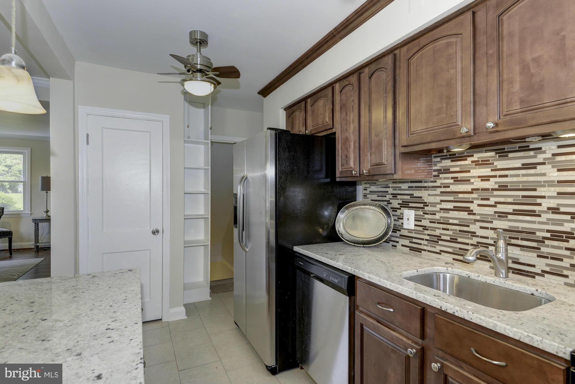 1901 Swansea Road Baltimore, MD 21239 - Photo 14 of 28 a kitchen with sink refrigerator and cabinets