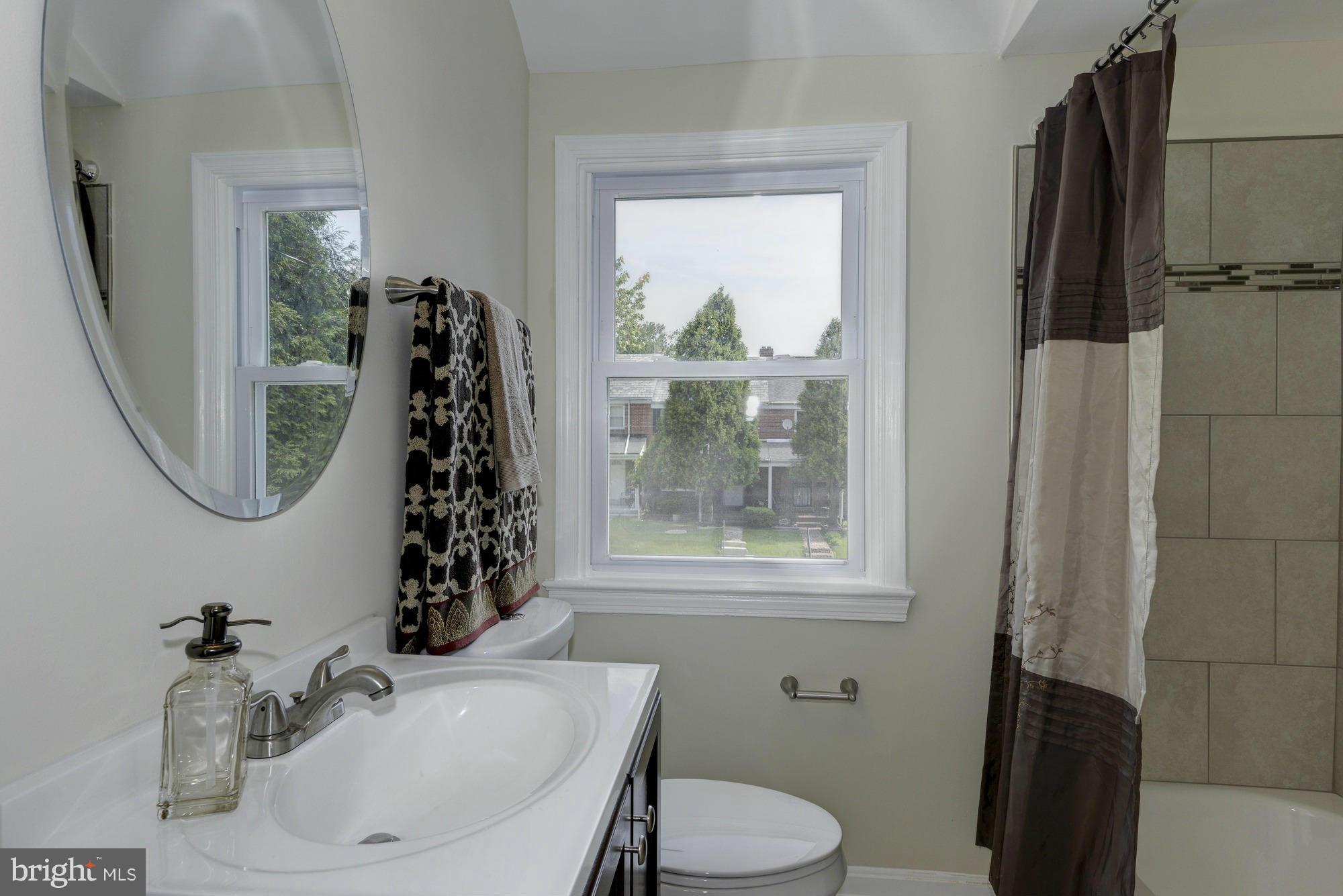 1901 Swansea Road Baltimore, MD 21239 - Photo 16 of 28 a bathroom with a sink toilet and a mirror
